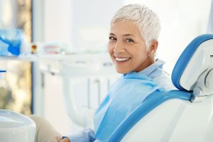 older woman smiling in dentist chair