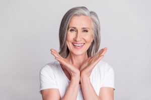 photo of cheerful aged woman with porcelain veneer smile